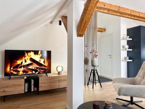 a living room with a fire in the fireplace at Apartman Romić in Vrlika