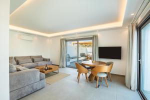 a living room with a couch and a table at Manos Villas in Karpathos