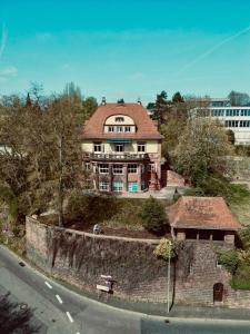 a large house on top of a stone wall at Boutique Apartment Villa Jaenisch in Kaiserslautern
