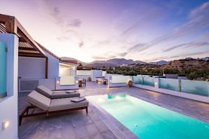 a villa with a swimming pool on a roof at Manos Villas in Karpathos