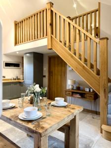 a wooden table with plates on it in a kitchen at Y Beudy Bach in Llanfor