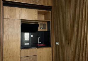 a room with a wall with a tv and a cabinet at La Perle Rare in Tangier +37 photos