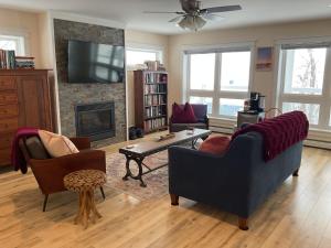 a living room with a couch and a fireplace at Roberts Lake House Room# 2 in Colchester