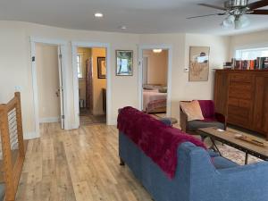 a living room with a couch and a bedroom at Roberts Lake House Room# 2 in Colchester