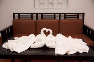 two towels on a bench with two swans at Sengao backpacker in Vang Vieng