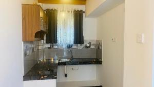 a kitchen with a sink and a window at Coco Wave Midigama in Midigama East