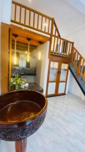 a large bowl in the middle of a room with a staircase at Coco Wave Midigama in Midigama East