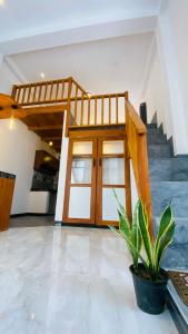 a room with a door and a potted plant at Coco Wave Midigama in Midigama East
