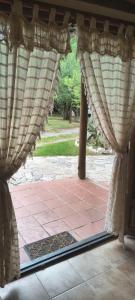 an open door to a patio with curtains at Paraíso Serrano in Casa Grande