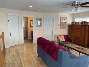 a living room with a blue couch and a table at Roberts Lake House Room #3 in Colchester