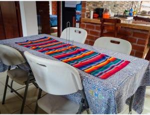 a table with a colorful blanket on top of it at CASITA Isabella in Tingo María