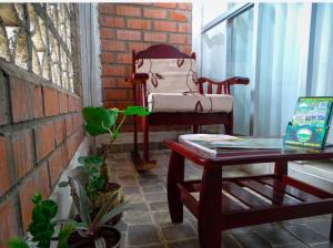 a chair sitting next to a table in a room at CASITA Isabella in Tingo María