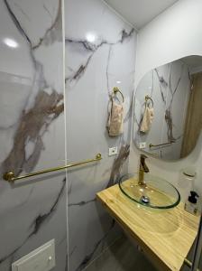 a bathroom with a sink and a mirror at Exclusive Tiny Loft in Usaquén in Bogotá