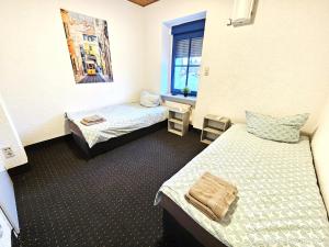 a room with two beds and a window at Monteur Oase Leipzig Nord in Schkeuditz
