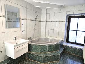 a bathroom with a tub and a sink at Monteur Oase Leipzig Nord in Schkeuditz +14 photos