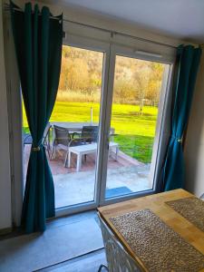 a sliding glass door with a view of a patio at à la claire fontaine in Vizille