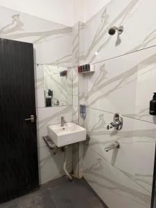 a bathroom with a sink and a shower at ReneeMysa in Indore