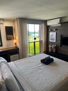 a bedroom with a large bed with two pillows on it at Flat Life Resort com vista do Lago in Brasília +46 photos