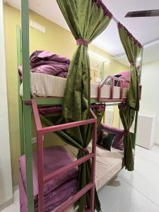 a bunk bed room with two bunk beds at ReneeMysa in Indore +8 photos