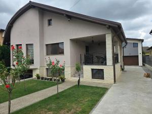 a large white house with a balcony in a yard at Casa MADE in Turda