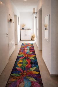 a hallway with a colorful rug on the floor at Giovanna Ferienwohnung in Müllenbach