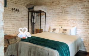 a bedroom with a bed with two bows on it at RIFUGIO DEL TRAMONTO in Monte Verde