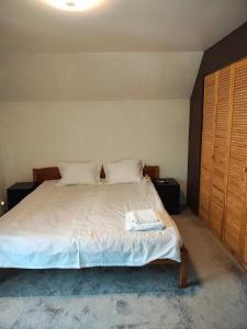 a bedroom with a bed with a book on it at Panaghie in Hangul