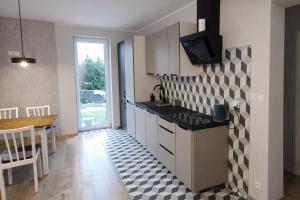 a kitchen with a sink and a table with a dining room at Dom Przyjaźni in Kędzierzyn-Koźle