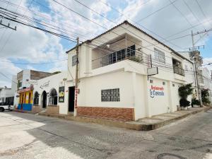 a white building on the corner of a street at Hotel Cascada in Ríohacha