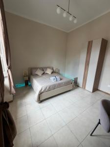 a bedroom with a bed and a tiled floor at The Reggia Nest in Caserta +15 photos