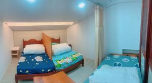 a small bedroom with a bed and a bed sqor at Chongguang Hotel in Tainan