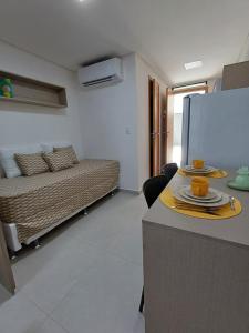 a room with a bed and a table with plates on it at Departamento ideal in Ipojuca