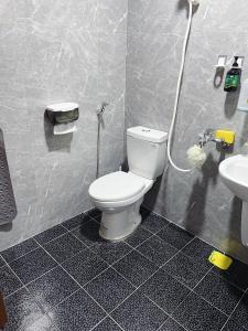 a bathroom with a toilet and a sink at Chongguang Hotel in Tainan