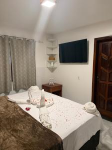a bedroom with a bed with a towel on it at Apartamento com sala e cozinha no morro da saudade in Morro de São Paulo +22 photos