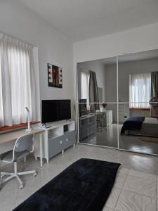 a living room with a bed and a large mirror at Grazioso bilocale a Legnano. in Legnano