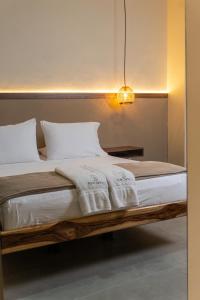 a bed with white blankets and pillows in a room at The Living Hub in La Dorada