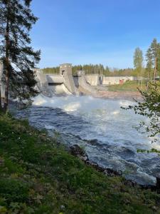 a dam on a river with water spraying overboard at Centerpoint Imatra in Imatra