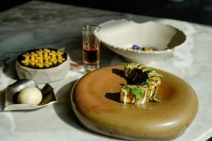 a table topped with a donut and a bowl of food at Ca' del Profeta Suites & SPA in Montegrosso dʼAsti +11 photos