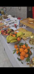 a table with many plates of fruit on it at Hôtel kairouan in Fez