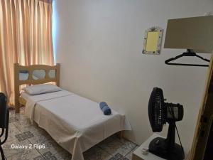a bedroom with a bed and a tv in it at Pousada do Luquinhas in Brasília