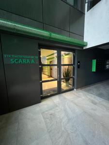 a entrance to a building with a glass door at marius in Chiajna