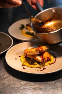 a plate with some food on a table at The Bottle & Glass Inn - Barn View - Room 2 in Henley on Thames