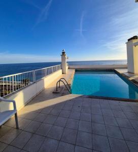 a swimming pool on a balcony with a view of the ocean at Royal Luxembourg Nice Prom' in Nice