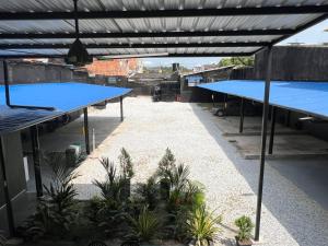 a group of blue tables on a building with plants at The Living Hub in La Dorada +13 photos