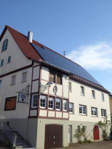 a large white building with a black roof at Ferienwohnung Eberhard in Schwäbisch Gmünd