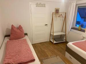 a room with two beds and a door with a window at Ferienwohnung Eberhard in Schwäbisch Gmünd +2 photos