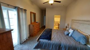 a bedroom with a bed and a ceiling fan at Country Resort in Bates City +8 photos
