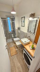 a bathroom with a sink and a toilet and a shower at Casa Bomba in San Mauro Torinese +24 photos