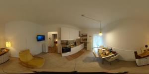 a large room with a kitchen and a living room at Casa Bomba in San Mauro Torinese