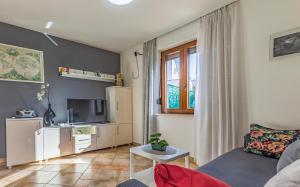 a living room with a couch and a tv at Good choice in Valbandon